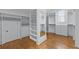 A very large walk-in closet with hardwood floors, shelving, drawers and hanging space at 5070 Riverlake Dr, Peachtree Corners, GA 30097