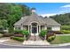 The clubhouse is a single-story building with a well-manicured lawn and meticulous landscaping at 5070 Riverlake Dr, Peachtree Corners, GA 30097