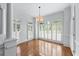 Bright dining area with hardwood floors, large windows, and plantation shutters at 5070 Riverlake Dr, Peachtree Corners, GA 30097