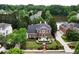 Beautiful brick home overlooking the lake has manicured lawns and established landscaping at 5070 Riverlake Dr, Peachtree Corners, GA 30097