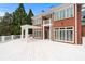 Large brick home with a white deck and pergola, offering beautiful outdoor living space at 5070 Riverlake Dr, Peachtree Corners, GA 30097