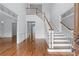 Bright foyer featuring a grand staircase, hardwood floors, and elegant architectural details, creating a welcoming ambiance at 5070 Riverlake Dr, Peachtree Corners, GA 30097