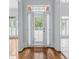 Bright foyer features glass front door, transom window, and plantation shutters at 5070 Riverlake Dr, Peachtree Corners, GA 30097