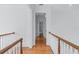 Hallway boasts hardwood floors, elegant trim, and natural lighting at 5070 Riverlake Dr, Peachtree Corners, GA 30097
