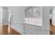 Hallway boasts built-in cabinets with decorative glass, hardwood floors, and elegant trim at 5070 Riverlake Dr, Peachtree Corners, GA 30097