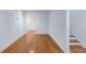 Bright hallway with hardwood floors and neutral paint at 5070 Riverlake Dr, Peachtree Corners, GA 30097