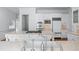 Bright kitchen featuring white cabinets, stainless appliances, and an island with a prep sink at 5070 Riverlake Dr, Peachtree Corners, GA 30097