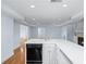 Charming kitchen boasting modern black appliances, white cabinetry, and durable countertops at 5070 Riverlake Dr, Peachtree Corners, GA 30097