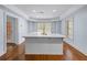 Spacious kitchen featuring a large white island with a sink and ample counter space and natural light at 5070 Riverlake Dr, Peachtree Corners, GA 30097