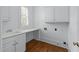 Laundry room features a sink, countertop space, and upper and lower cabinets at 5070 Riverlake Dr, Peachtree Corners, GA 30097