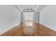 Spacious living room featuring hardwood floors, crisp white walls, and elegant architectural columns with an open floor plan at 5070 Riverlake Dr, Peachtree Corners, GA 30097