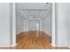 Spacious living room featuring hardwood floors, crisp white walls, and elegant architectural columns at 5070 Riverlake Dr, Peachtree Corners, GA 30097