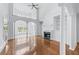 Open living room with soaring ceilings, hardwood floors, fireplace, and large windows for ample light at 5070 Riverlake Dr, Peachtree Corners, GA 30097