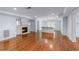 Open concept living room with fireplace, built-ins and hardwood flooring at 5070 Riverlake Dr, Peachtree Corners, GA 30097
