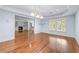 Bright open living room with fireplace, hardwood floors, and large window at 5070 Riverlake Dr, Peachtree Corners, GA 30097