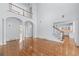 Bright and airy living room boasting hardwood floors, second story over look, and stairway access at 5070 Riverlake Dr, Peachtree Corners, GA 30097