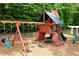 A community playground featuring a swing set, climbing structures, and a slide for children at 5070 Riverlake Dr, Peachtree Corners, GA 30097