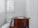 Powder room features pedestal sink, ornate wood vanity, and traditional fixtures at 5070 Riverlake Dr, Peachtree Corners, GA 30097