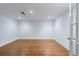Open room featuring neutral walls and wooden floors at 5070 Riverlake Dr, Peachtree Corners, GA 30097