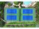Well-maintained tennis courts provide recreational opportunities within a lush, landscaped community at 5070 Riverlake Dr, Peachtree Corners, GA 30097