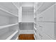 Walk-in closet equipped with multiple shelves, drawers and wooden floors at 5070 Riverlake Dr, Peachtree Corners, GA 30097