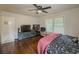 Cozy bedroom featuring hardwood floors, a ceiling fan, and abundant natural light from a window at 646 Quillian Ave, Decatur, GA 30032
