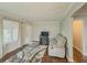 Cozy living room with hardwood floors, neutral walls, and a large window at 646 Quillian Ave, Decatur, GA 30032