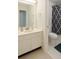Well-lit bathroom with a clean vanity, mirror, and a shower with a decorative curtain at 802 Lismore Se # 2, Smyrna, GA 30080
