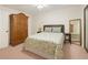 Comfortable bedroom with wardrobe, a mirror, and a bed with colorful bedding at 802 Lismore Se # 2, Smyrna, GA 30080