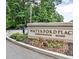 Waterford Place Condominium Homes sign surrounded by landscaped flower beds and mature trees at 802 Lismore Se # 2, Smyrna, GA 30080