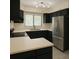 Modern kitchen featuring black cabinetry, stainless steel appliances, and a double basin sink at 802 Lismore Se # 2, Smyrna, GA 30080