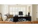 Brightly lit office with shuttered windows, a black executive desk and chair, and a leather couch at 802 Lismore Se # 2, Smyrna, GA 30080