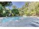 Community pool with surrounding greenery and lounge chairs at 802 Lismore Se # 2, Smyrna, GA 30080
