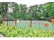Community tennis court surrounded by lush greenery and orange flowers at 802 Lismore Se # 2, Smyrna, GA 30080