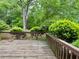 Wooden back deck surrounded by lush greenery, providing a private outdoor space at 3419 White Sands Way, Suwanee, GA 30214