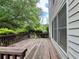 Wooden deck with a bench overlooking serene trees, perfect for relaxation and enjoying nature at 3419 White Sands Way, Suwanee, GA 30214