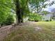 Serene backyard featuring lush greenery and mature trees, perfect for relaxing and enjoying nature's beauty at 3419 White Sands Way, Suwanee, GA 30214