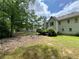 View of a spacious backyard featuring lush green grass and mature trees, ideal for outdoor activities at 3419 White Sands Way, Suwanee, GA 30214