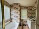 Bathroom featuring world map wallpaper, a tub, large window and vanity area at 3419 White Sands Way, Suwanee, GA 30214