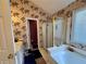 Bathroom featuring world map wallpaper, a tub, shower and vanity area at 3419 White Sands Way, Suwanee, GA 30214