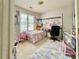 Bedroom featuring a bed with a colorful rug, a window, and desk area at 3419 White Sands Way, Suwanee, GA 30214