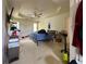 Bedroom featuring a large bed with a tray ceiling, windows, and a fan at 3419 White Sands Way, Suwanee, GA 30214