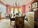 Dining room featuring ample seating, a chandelier, and large windows draped in valances at 3419 White Sands Way, Suwanee, GA 30214