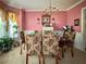 Spacious dining area with a floral patterned dining set, chandelier, and decorative walls at 3419 White Sands Way, Suwanee, GA 30214
