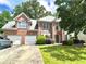 Charming two-story brick home featuring a well-manicured lawn and an attached two-car garage at 3419 White Sands Way, Suwanee, GA 30214