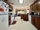 Functional kitchen with white appliances, wooden cabinetry, and a dining area for a cozy meal setting at 3419 White Sands Way, Suwanee, GA 30214