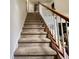 Carpeted staircase with white banisters and wooden handrail leads to upper floors, offering a comfortable transition at 3419 White Sands Way, Suwanee, GA 30214