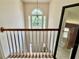 Bright stairwell with a chandelier and large window offering natural light at 3419 White Sands Way, Suwanee, GA 30214