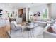 Bright open concept living room featuring modern decor, hardwood floors, and seamless flow into the kitchen at 515 Motivation Nw Cir, Atlanta, GA 30309