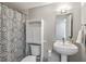 Cozy bathroom featuring a pedestal sink, white vanity, and a patterned shower curtain at 1501 Clairmont Rd # 1522, Decatur, GA 30033